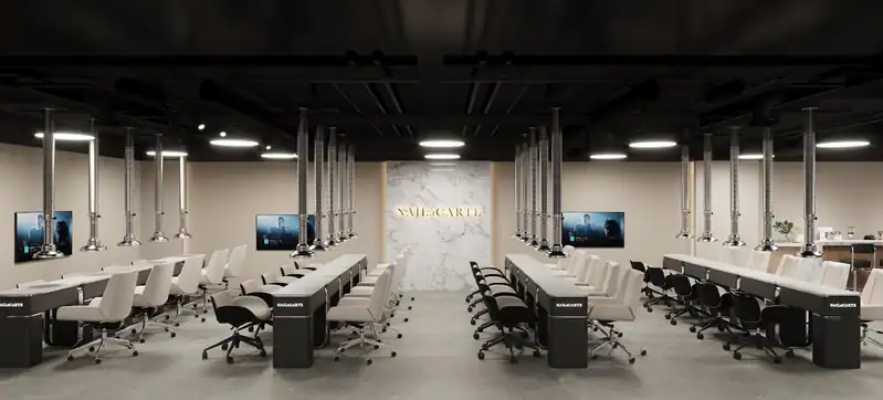 Nail art training room with manicure stations and digital displays.
