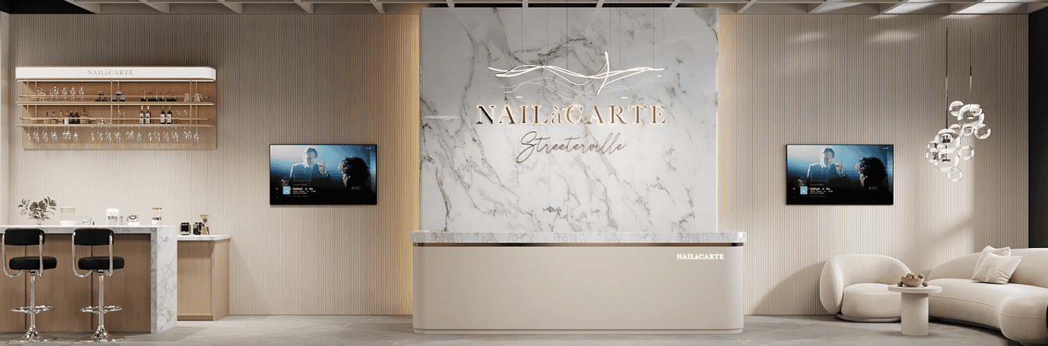 Luxurious nail salon reception area with modern design, marble accents, and stylish decor.